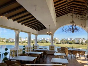 Enjoy al fresco dining with a view of the serene garden and water feature.