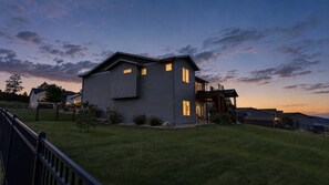 A two-story house with a front deck and a small porch.