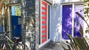 A building with a stone facade, a red-framed door, and a purple-framed door. - StayCentral - Fairfield 4Br Home (Fairfield)