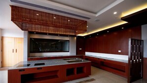 A modern kitchen with a central island, wooden cabinets, and a built-in oven.