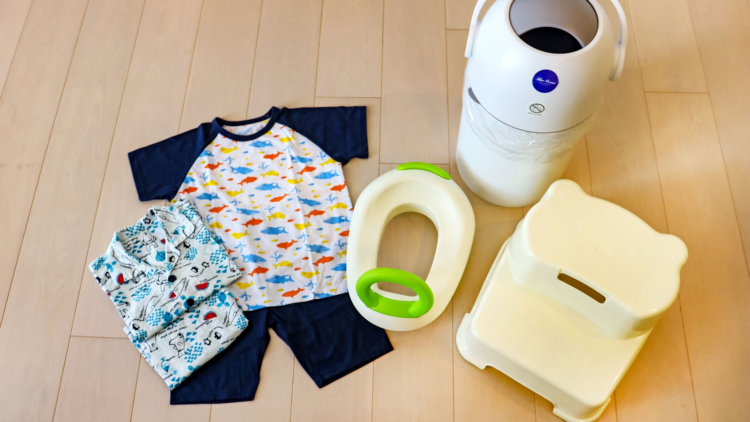 A child's potty training setup including a potty, toilet paper, and a potty seat.