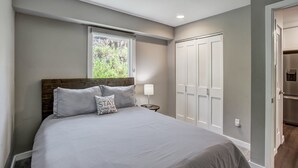A bedroom with a bed, a nightstand, a window, a wardrobe, and a door. - A Ridge above the Rest!  New Remodel and High End Upgrades (Breckenridge)