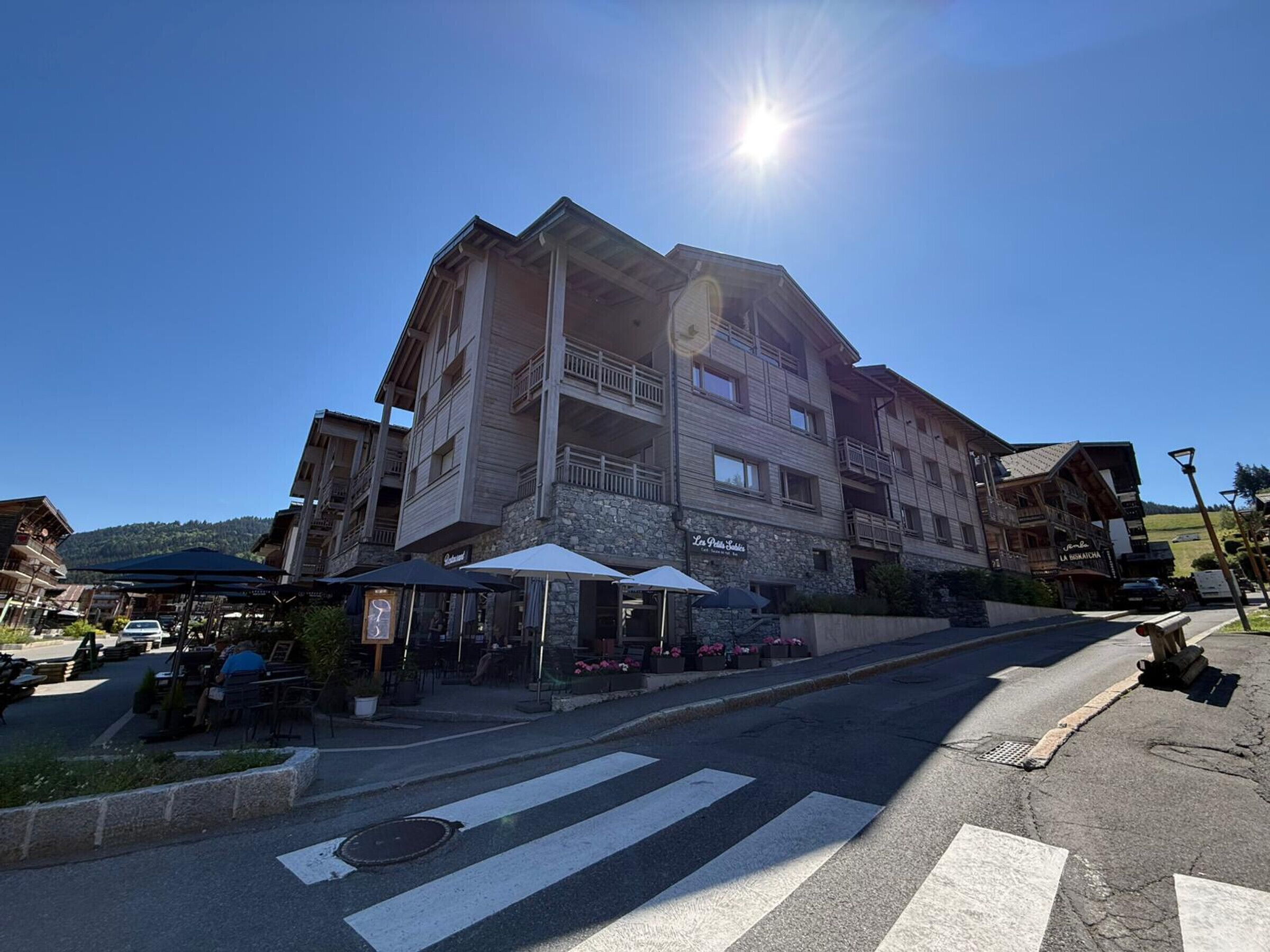 A multi-story hotel with outdoor seating and a clear view of the surrounding area.