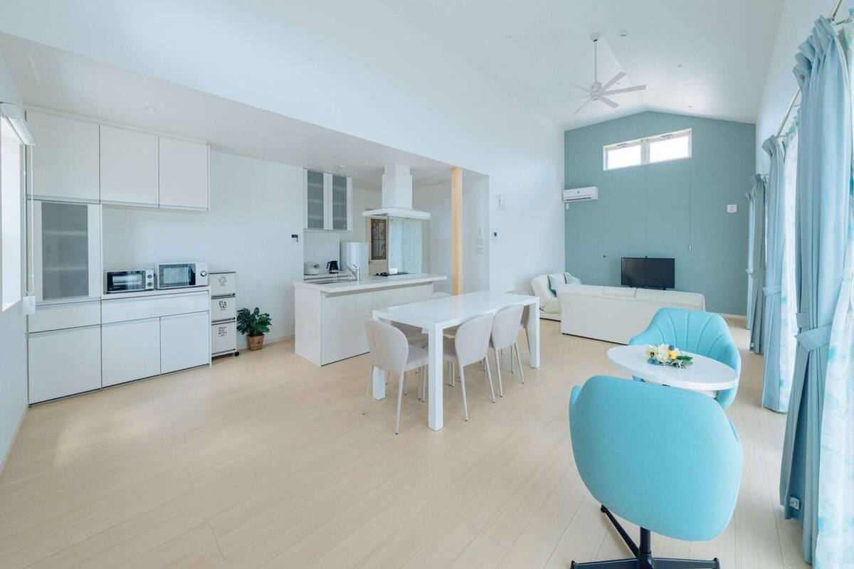 A modern apartment with a kitchen, dining area, and living room.