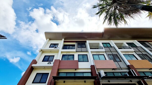 A multi-story building with a flat roof, multiple balconies, and air conditioning units. - TP House @town (Phuket)
