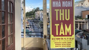 A balcony with a sign advertising a business. - Thu Tam Hotel (Cam Ly - Da Lat)