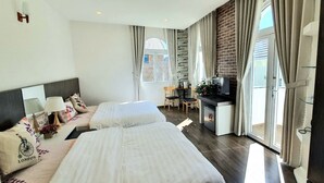 A hotel room with two beds, a desk, a TV, and a view of the outdoors. - Pho Hoa Boutique Villa (Cam Ly - Da Lat)