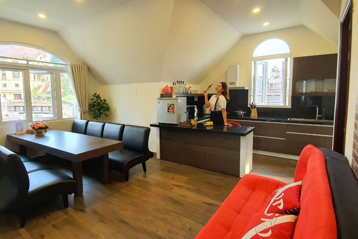 A modern apartment with a dining area, kitchen, and living space.
