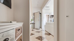 A hallway with a white dresser, a door leading to a bathroom, and a white sofa in the background. - 💥💥💥"Venere Suite" -  in the heart of Florence! A/C - WiFi superfast! 💥💥💥 (Firenze)