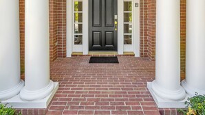 A brick entrance with white columns and a black door, number 121 above. - LakeViews, Indoor/Outdoor Pools, HotTub & Fire Pit (Branson)
