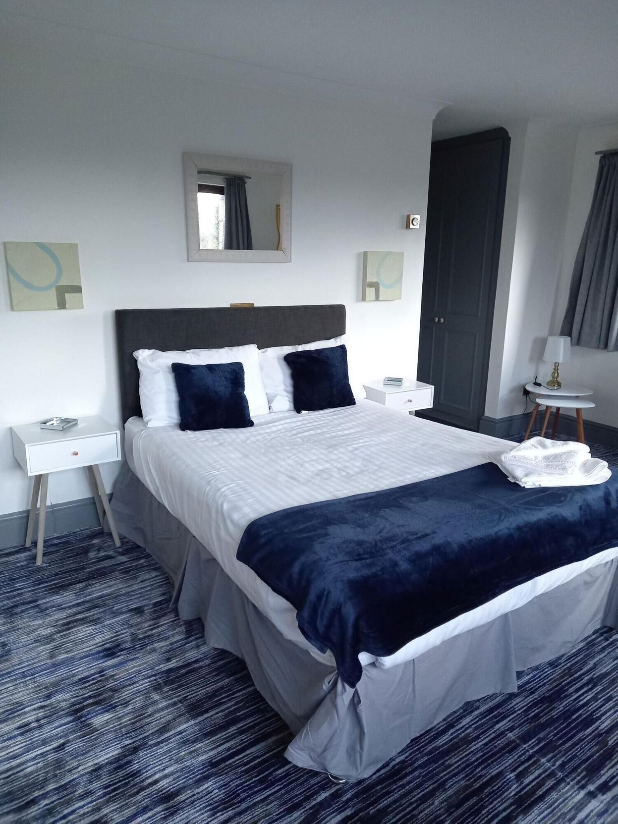Desk, iron/ironing board, bed sheets