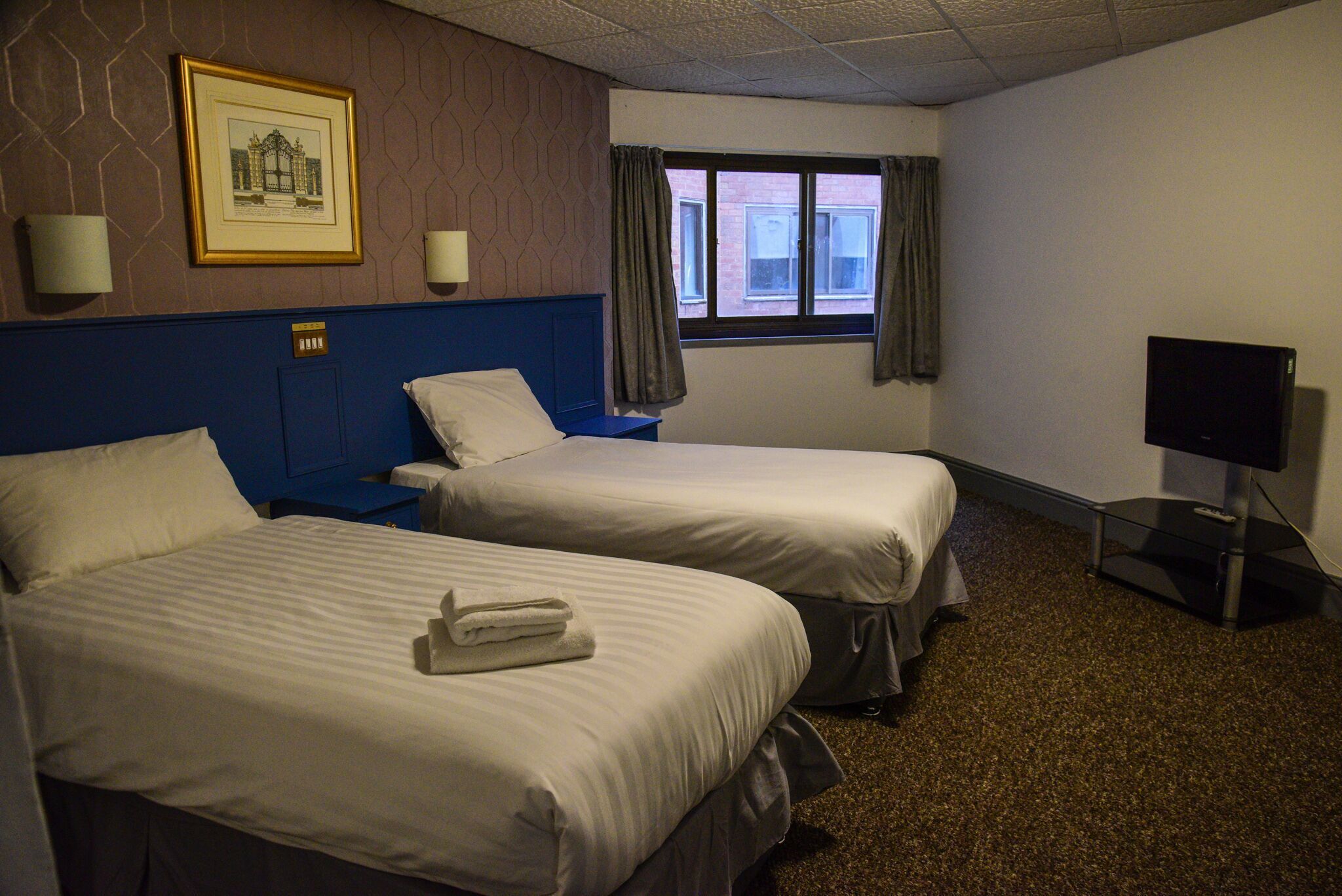 Desk, iron/ironing board, bed sheets
