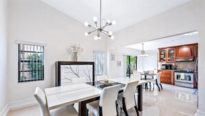 A modern kitchen with wooden cabinets and a stainless steel stove.