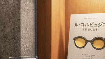A display with a book and a pair of glasses, a sign, and a shelf.