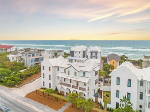 A coastal residential area with white houses, a road, and the ocean in the background. - Seaclusion at Seagrove|Private Deeded Beach|Resort Style Heated Pool (Santa Rosa Beach)