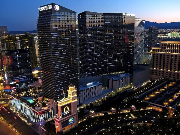A high-rise hotel with multiple floors, a prominent sign, and a well-lit facade.