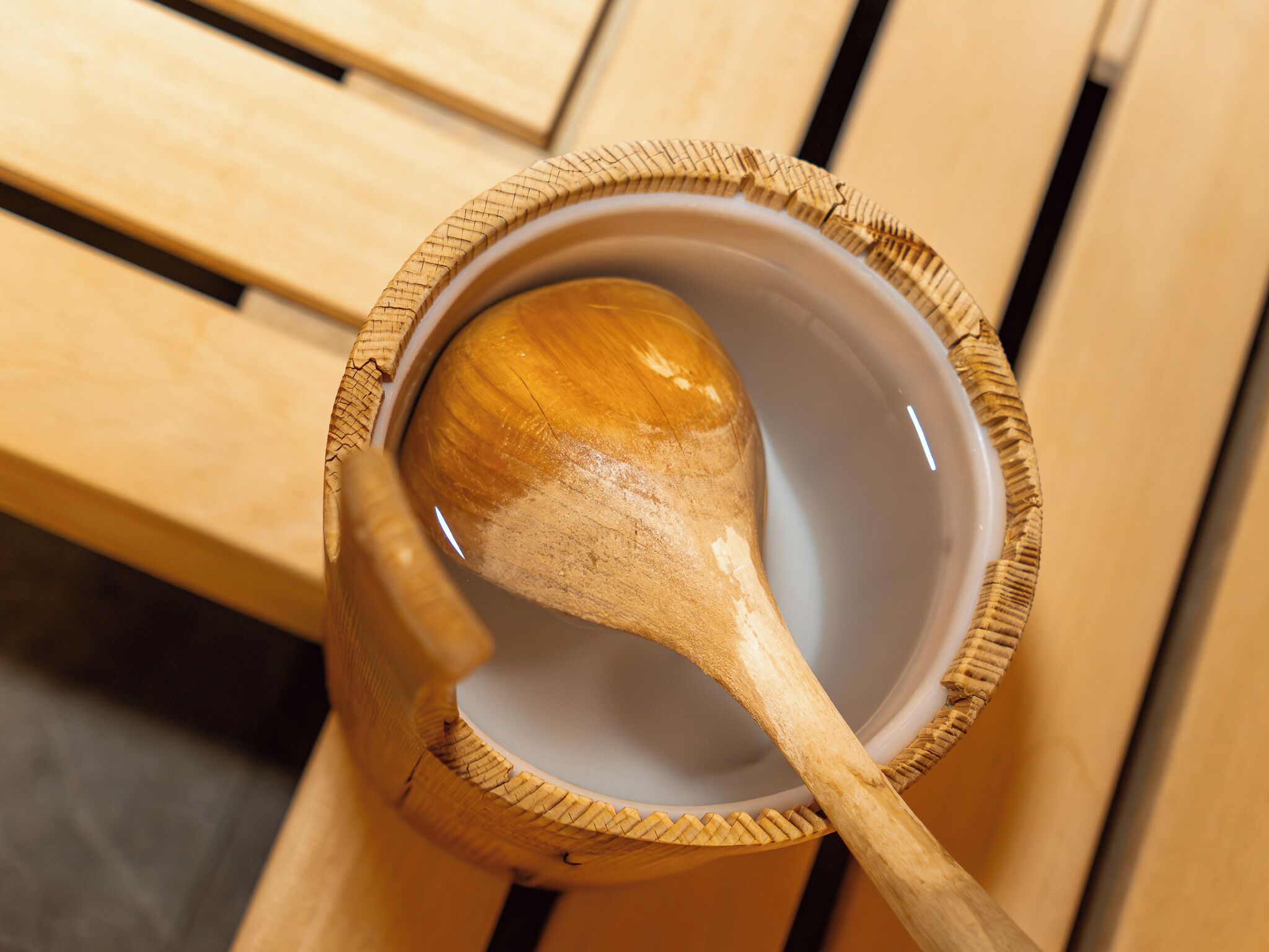 A wooden spoon in a ceramic bowl.