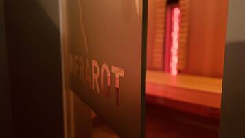 A glass door with the inscription "INFRAROT" and a blurred interior view.