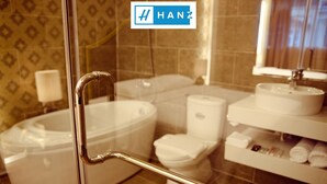 A bathroom with a bathtub, toilet, and sink.