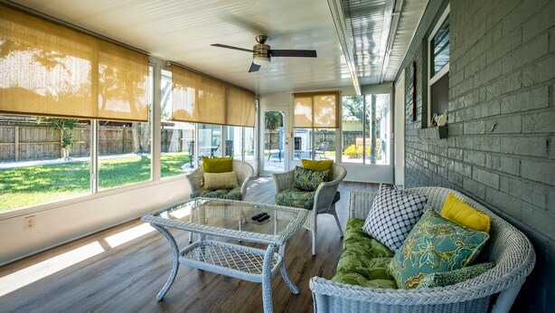 A sunroom with wicker furniture, large windows, and a ceiling fan. - Sweet Home Ponte Verdra: TPC Golf+Park+Outdoor Fireplace+ Nearby Beach Access！ (Ponte Vedra Beach)