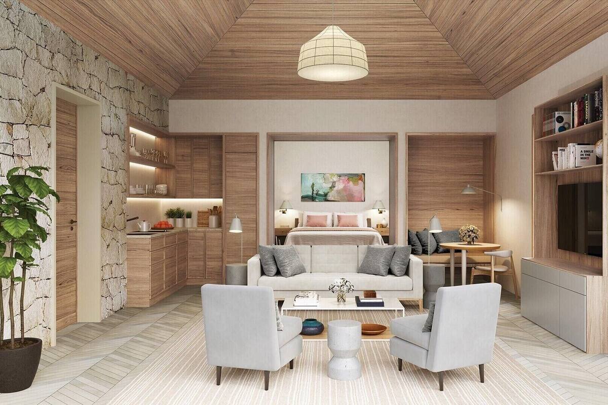 A modern living room with a sofa, chairs, a coffee table, a painting, and a bookshelf.