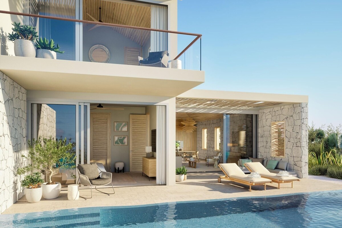 A modern two-story house with a swimming pool, outdoor seating, and potted plants.