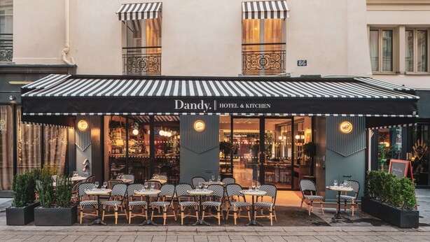 A hotel named Dandy Hotel & Kitchen with outdoor seating and a striped awning. - Dandy Hotel  (Paris)