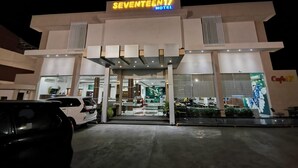 A hotel with a modern design, featuring a prominent entrance and a sign that reads 'SEVENTEEN17 HOTEL.'