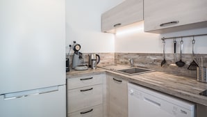 A modern kitchen with a built-in dishwasher, a coffee maker, and a kettle. - Le Duplex du Lac d'Orient #3 - Near the lake (Mesnil-Saint-Père)