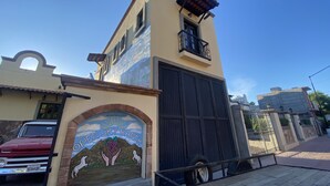 A building with a mural of a ranch scene and a gated entrance. - Honeymoon suite with private jacuzzi DISCOUNTED RATE (Loreto)