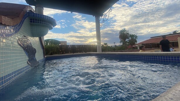 A swimming pool with a tiled edge and a decorative hand motif. - Honeymoon suite with private jacuzzi DISCOUNTED RATE (Loreto)