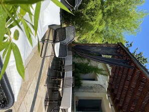 An outdoor patio area with a dining set, a covered seating area, and a wooden fence. - Character house | Uzès & Pont du Gard (Saint Maximin)