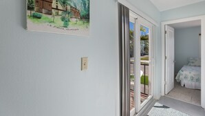 A hallway with a painting of a building labeled "LA PLAYITA, HOLMES BEACH".