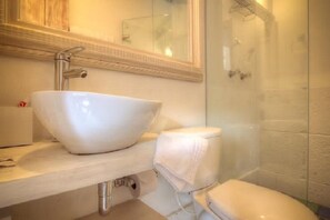 A bathroom with a white sink, a toilet, and a glass shower enclosure. - Splendid Colonial Villa with Rooftop & Jacuzzi (Cartagena)