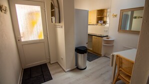 A compact kitchen with a refrigerator, a sink, and a small countertop.