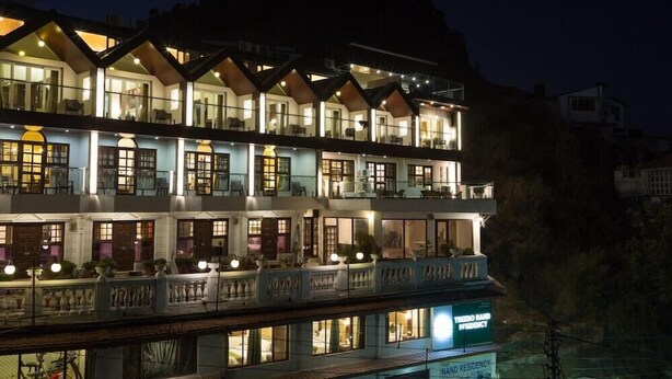 A multi-story hotel with balconies, large windows, and a sign indicating it is a 'NAND RESIDENCY'. - Treebo Nand Residency (Dehradun)