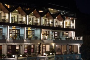 A multi-story hotel with balconies, large windows, and outdoor seating areas. - Treebo Nand Residency (Dehradun)