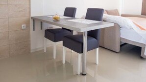 A modern hotel room with a bed, a desk, and two chairs. - ♥Apartmani Kankaras | Sea View - Quiet Quarter♥ (Tivat)