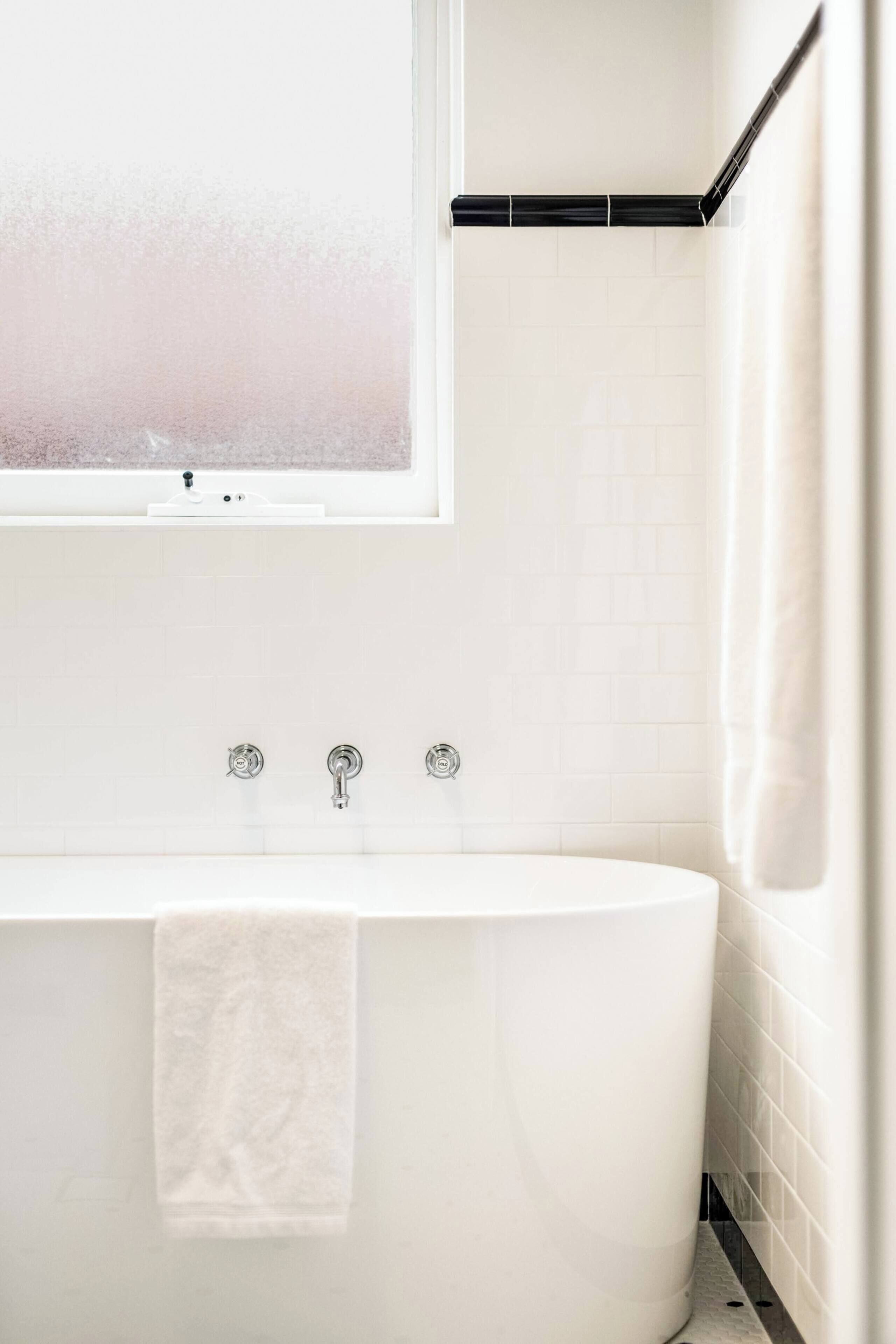 Bathtub, hair dryer, towels, shampoo