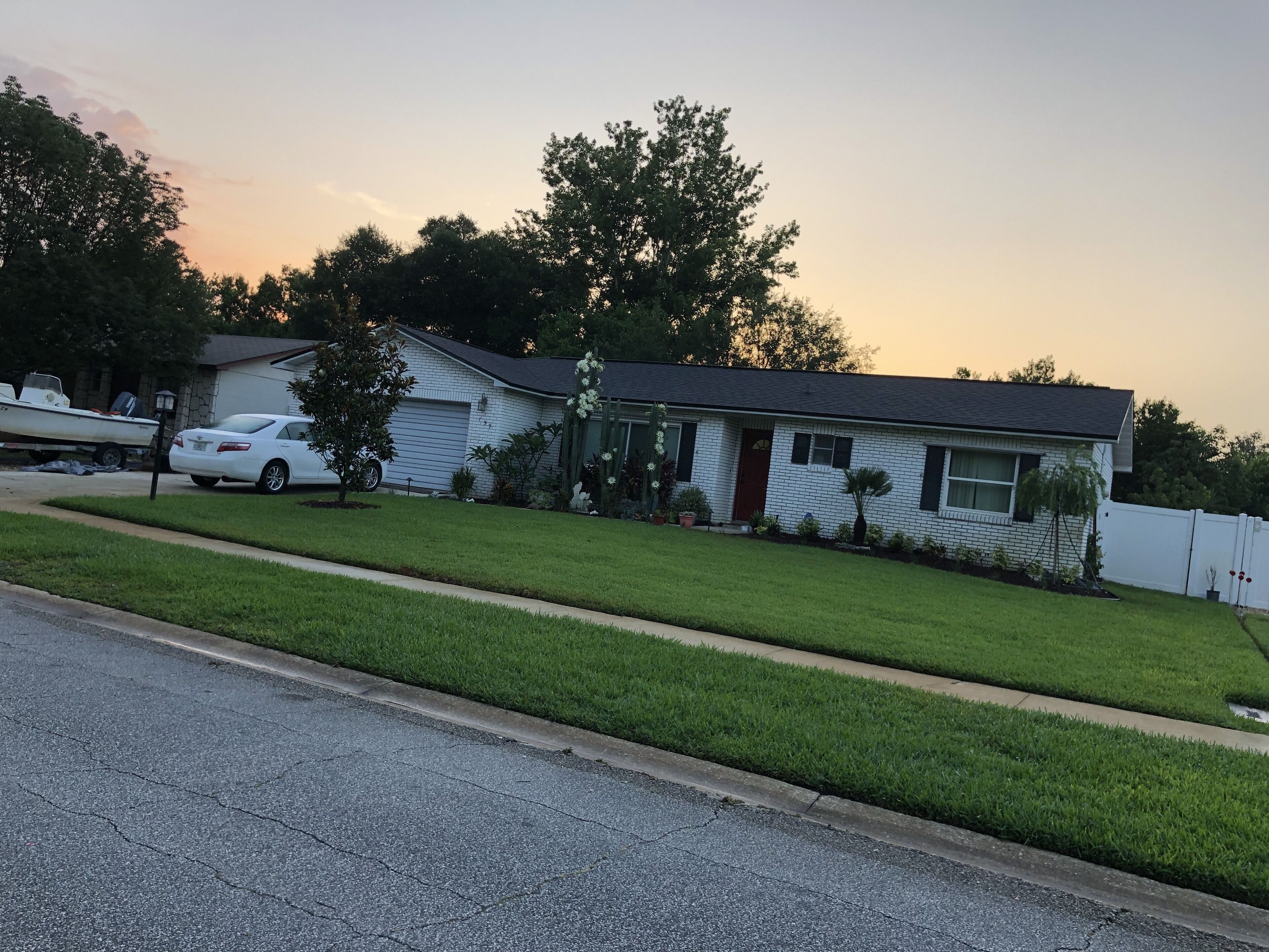 A residential house with a garage, a driveway, and a lawn.