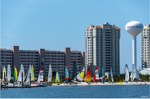 A marina with sailboats and a tall building labeled "NAVARRE BEACH" in the background.