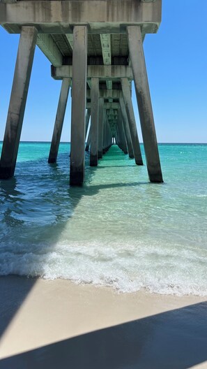 A pier extending into clear turquoise water with a sandy beach at the end. - Gulf Front Escape-Panoramic East Views & Oversized Balcony (Navarre)