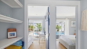 A bedroom with a bed, a desk, and a view of an outdoor swimming pool. - Laguna vacation home pool Sauna jacuzzi (Laguna Hills)