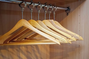 A wooden hanger rack with multiple hangers. - Royal Square Hotel - NEC and Birmingham Airport (Birmingham)