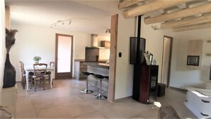 Une cuisine moderne dotée d’un îlot central, de tabourets de bar et d’un coin repas avec des chaises.