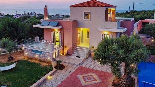 A modern two-story house with a balcony, a small garden, and a patterned walkway. - Cypress Village - Lux villa 5' from beach (Δαράτσος)