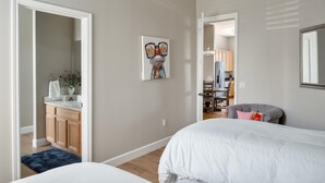 A bedroom with a bed, a chair, a dresser, and a mirror. - Walk to TPC | Pinnacle Peak Views | Gated Retreat (Scottsdale)
