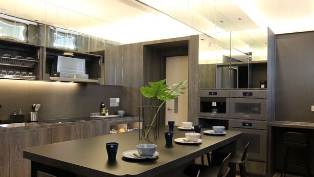 A modern kitchen with a central island, bar stools, and a large mirror. - ST Signature Jalan Besar, SHORT OVERNIGHT, 13 hours: 6PM-7AM (Singapore)