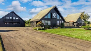A modern building with a large glass facade and a sign indicating online booking availability. - Ocean Shores cozy chalet located within steps from the beach (Ocean Shores)