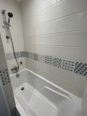 Combined shower/tub, hair dryer, towels, soap